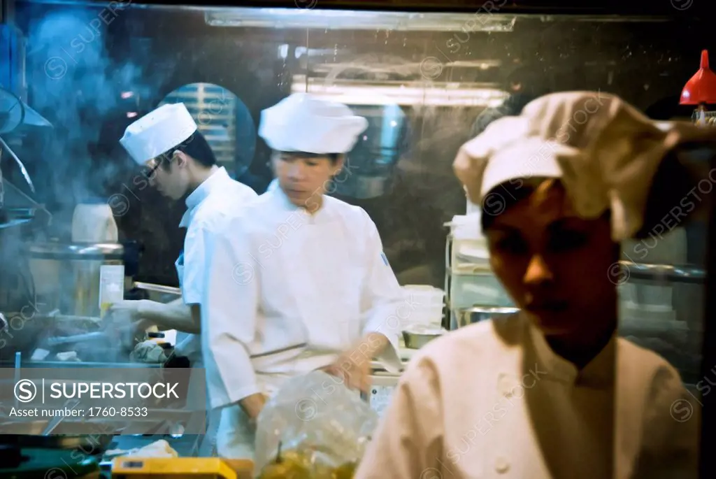 Hong Kong, Sheung Wan, Cooks in one of the many restaurants located in the renovated Western Market firehouse, prepare a meal.
