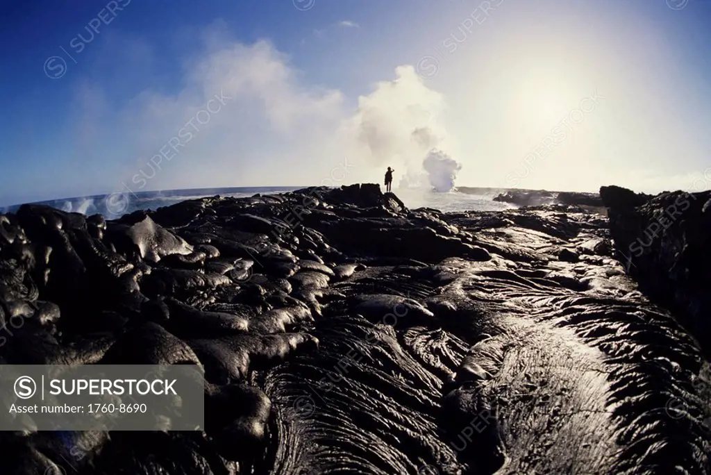 Hawaii, Big Island, Hawaii Volcanoes National Park, East Rift Zone, Person observing lava flow into ocean in distance.