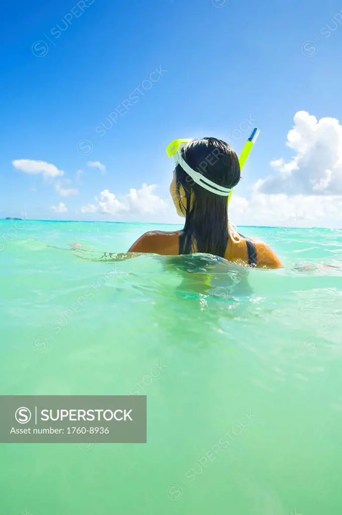 Hawaii, Oahu, Lanikai, Young Japanese woman wearing snorkle gear in the ocean.