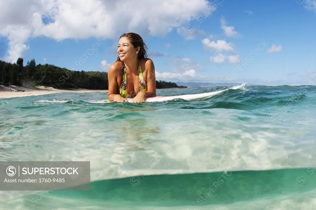 Hawaii, Oahu, Beautiful surfer girl in the ocean.
