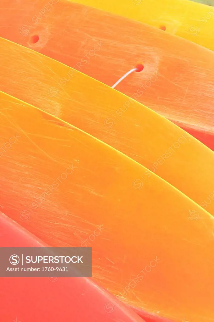 Hawaii, Oahu, Pattern shot of orange yellow Kayaks stacked on each other.