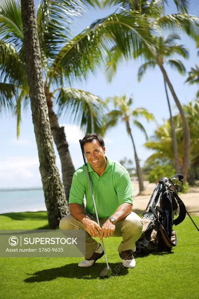 Hawaii, Oahu, Male golfer on golf course.