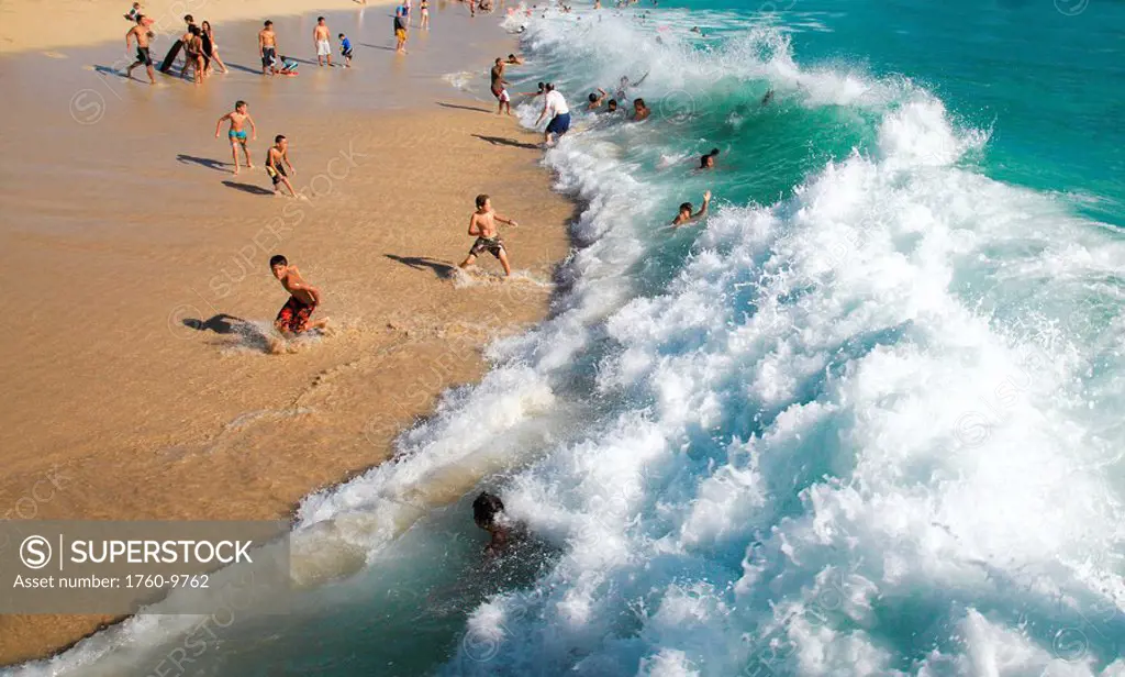 Hawaii, Waikiki Beach crowded with tourists and children on a sunny day.