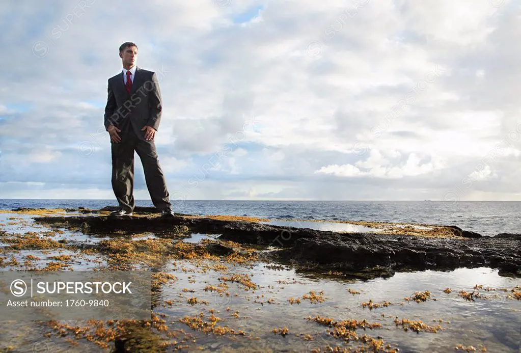 Hawaii, Oahu, Business man in his suit at rocky coastline.