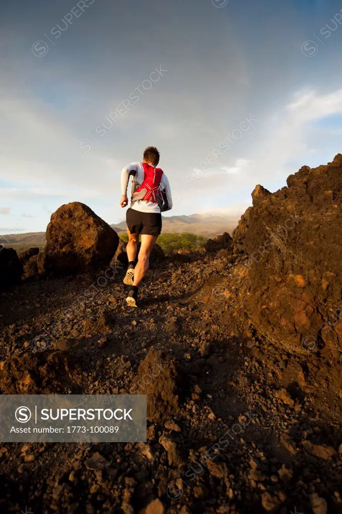 Man running on rocky rural trail