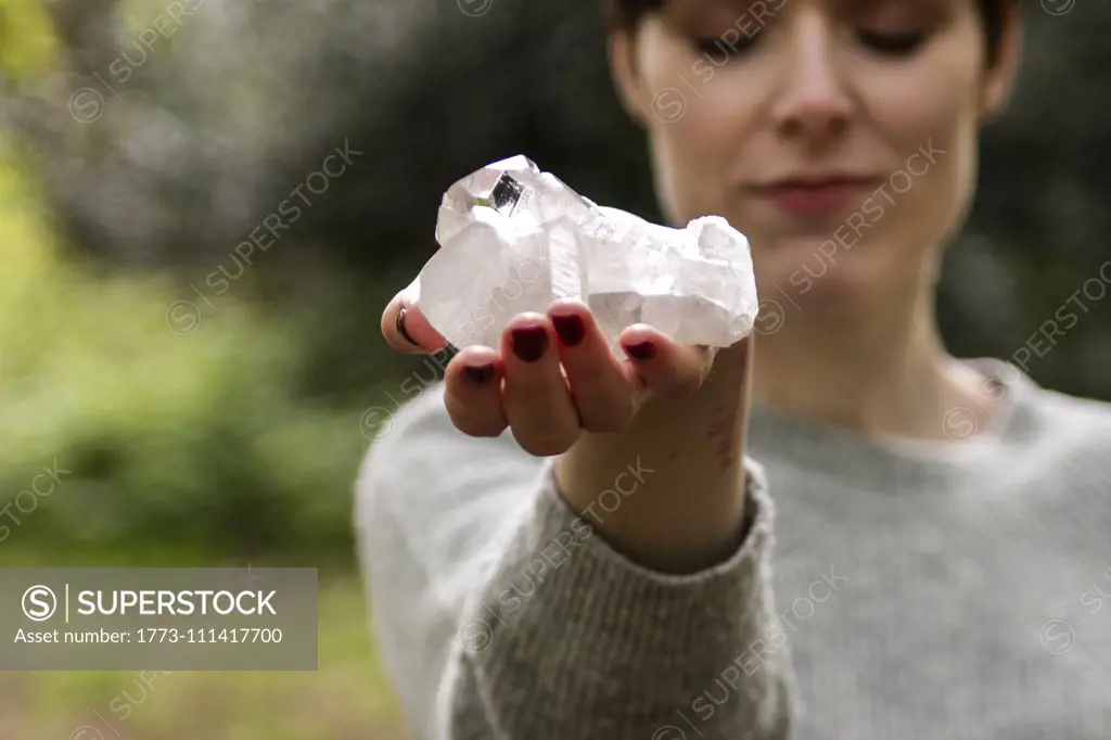 Woman holding healing crystal for Reiki