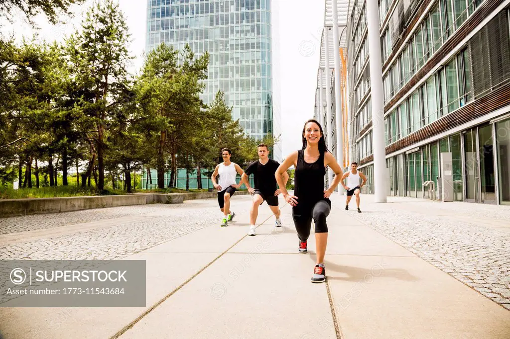 Personal trainers doing outdoor training in urban place, Munich, Bavaria, Germany