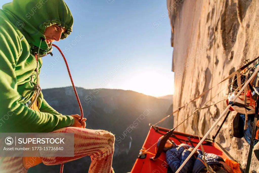 Two mountaineers in a portaledge on The Nose, El Capitan, Yosemite National Park.