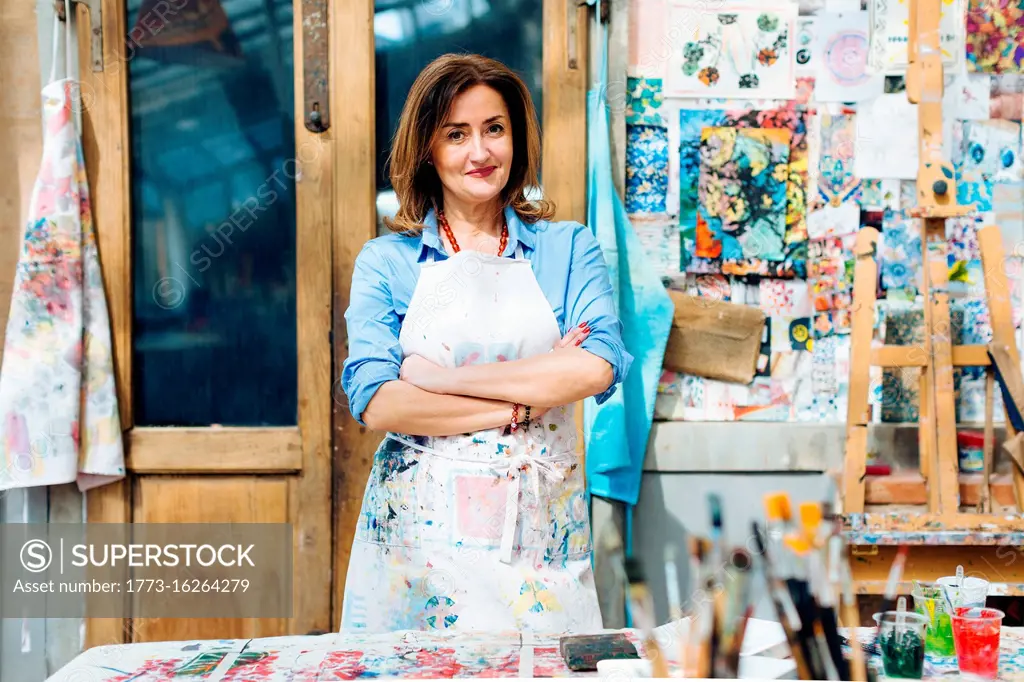 Portrait of female artist in creative studio, smiling
