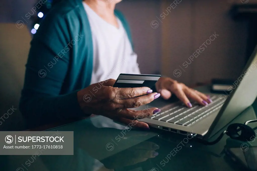 Woman shopping on laptop with credit card