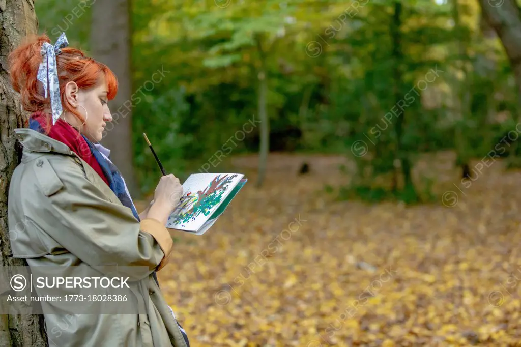 Artist painting in woodland