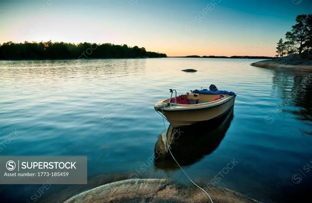 Boat docked in still lake