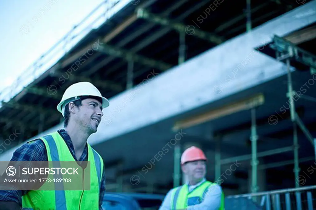 Construction workers talking on site