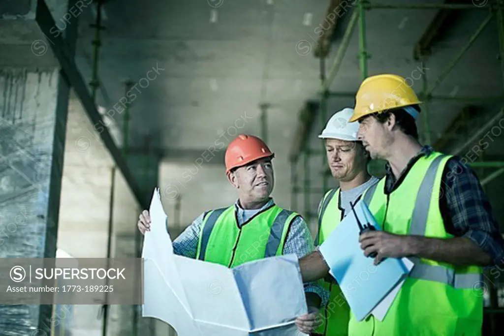 Construction workers reading blueprints