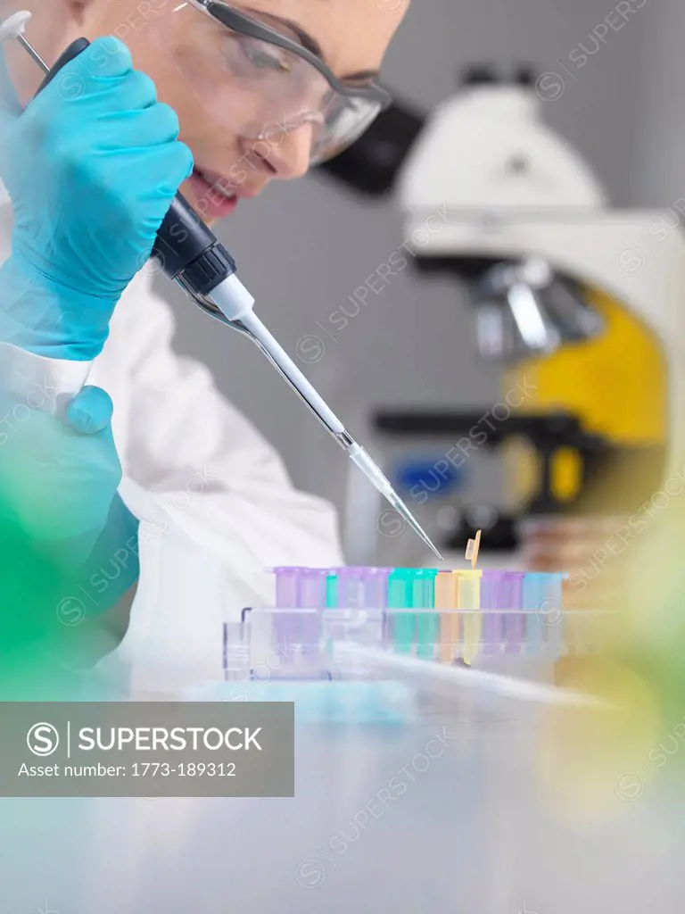 Scientist pipetting DNA sample in tubes