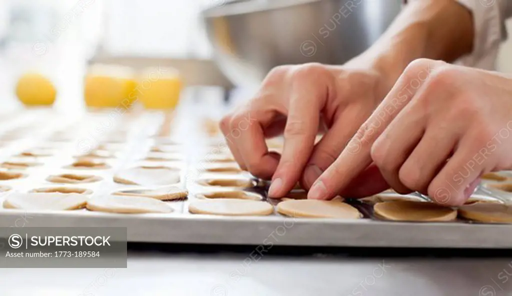 Baker shaping pastry in kitchen