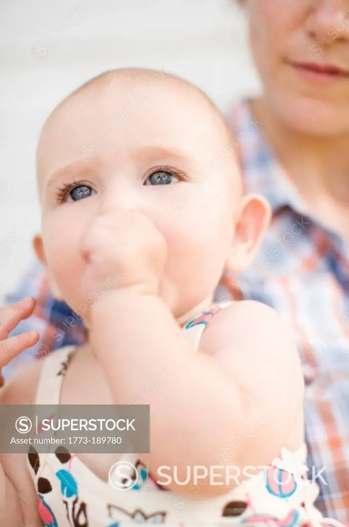 Baby girl sucking her thumb