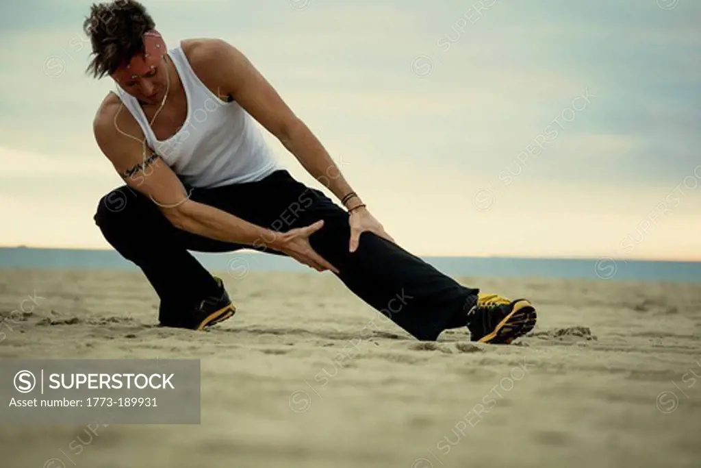 Man stretching on beach