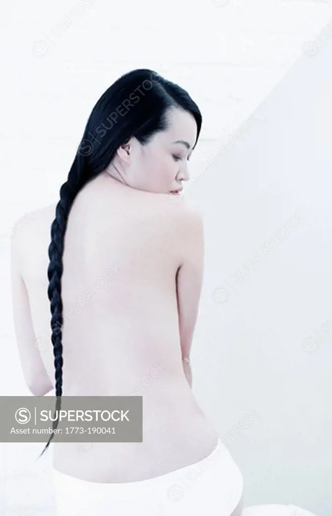 Nude woman with braided hair