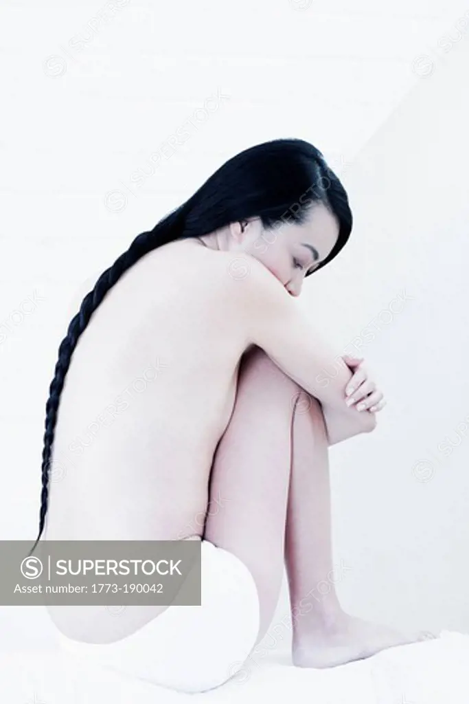 Nude woman with braided hair
