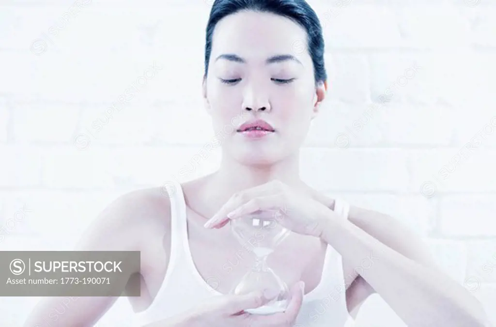 Woman holding hourglass