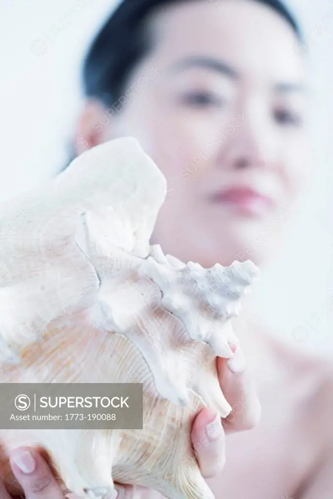 Woman showing conch shell