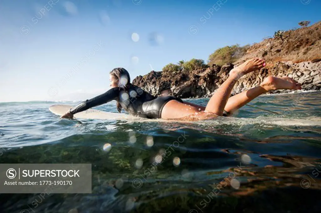 Surfer paddling in ocean