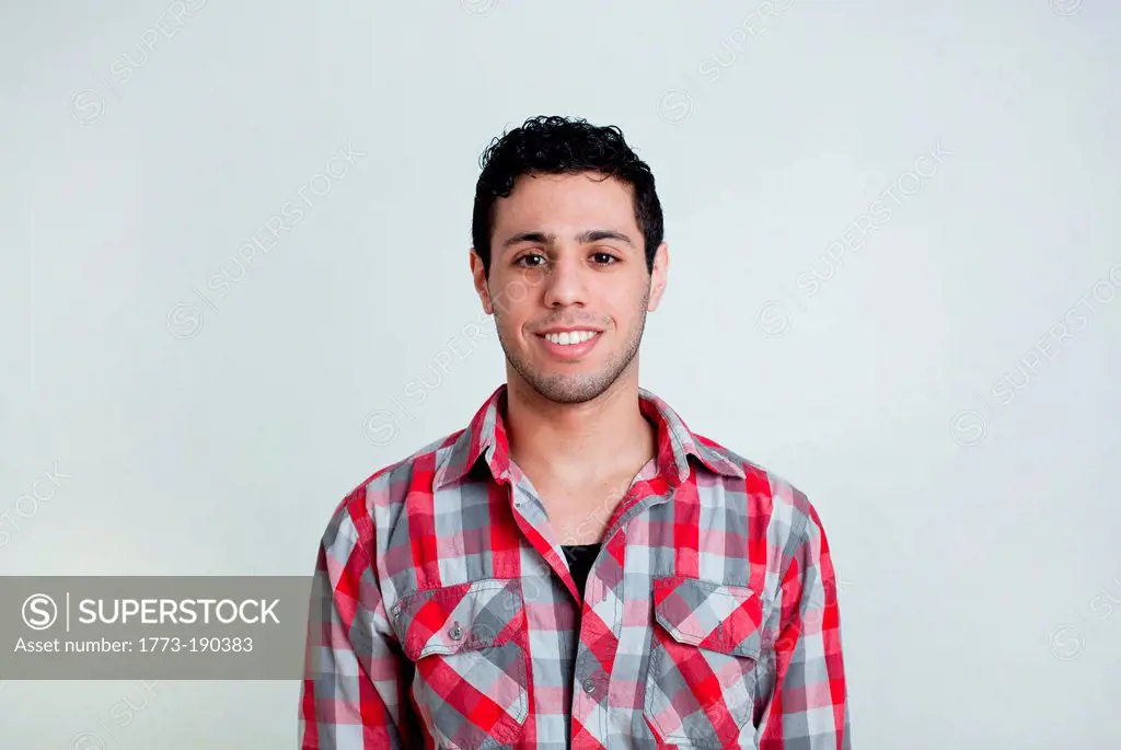 Portrait of young Hispanic man, studio shot