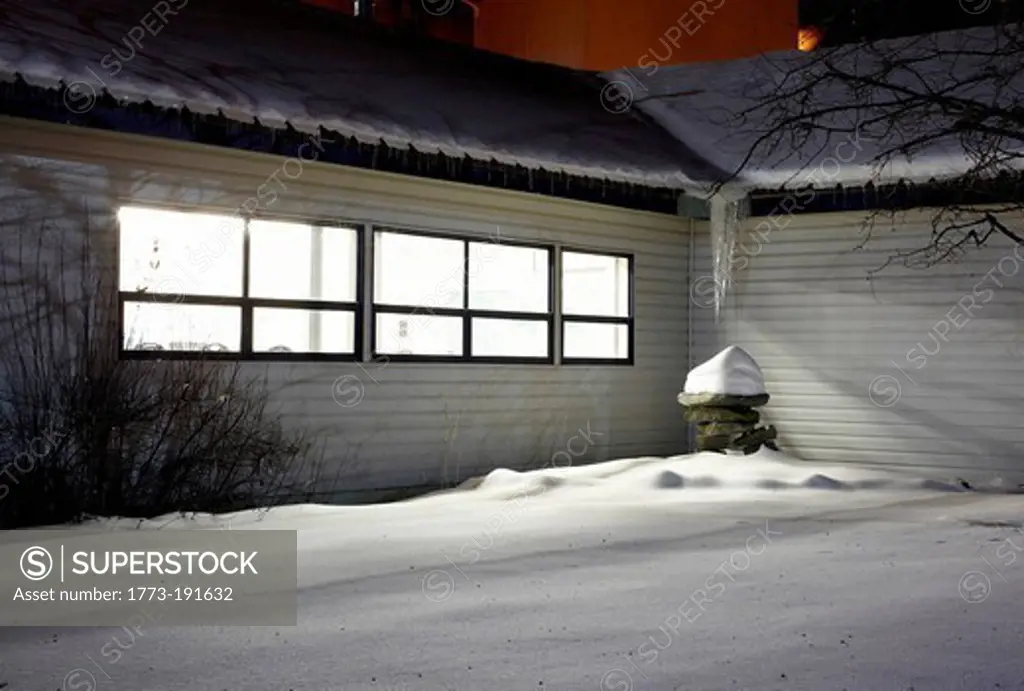House window lit up on snowy night