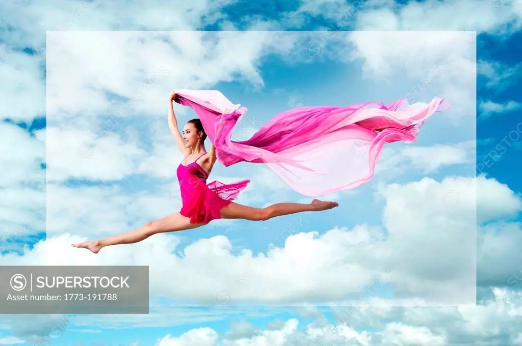 Ballerina leaping against cloudy sky