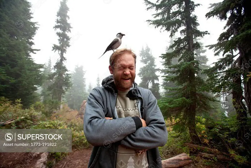 Man with Gray Jay on his head, Garibaldi Provincial Park, British Columbia, Canada
