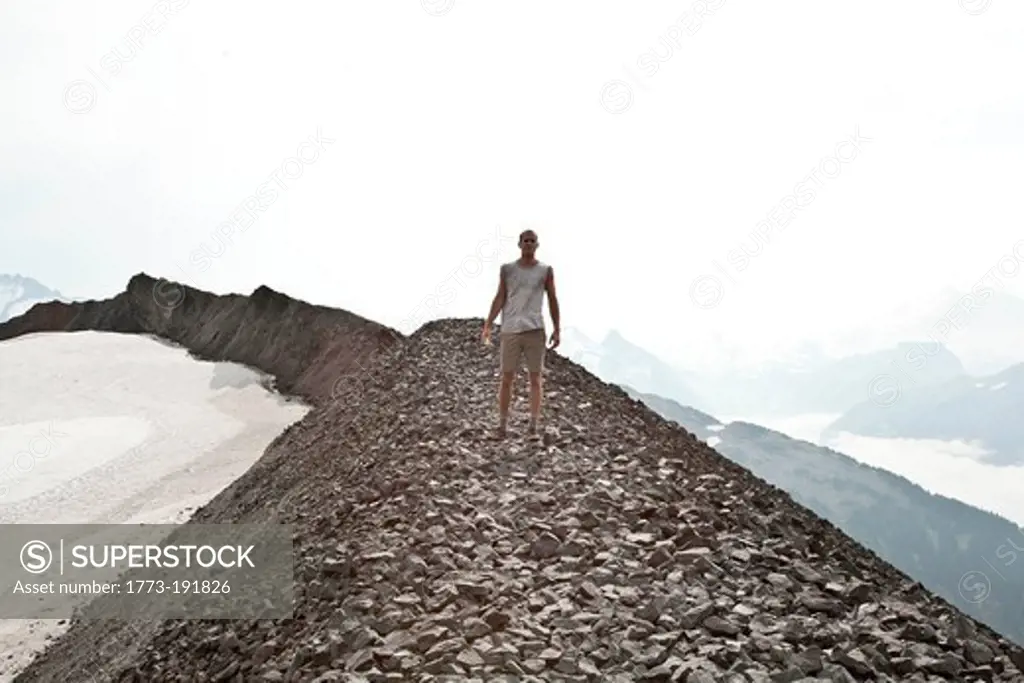 Man standing on rocks at Black Tusk, Garibaldi Provincial Park, British Columbia, Canada