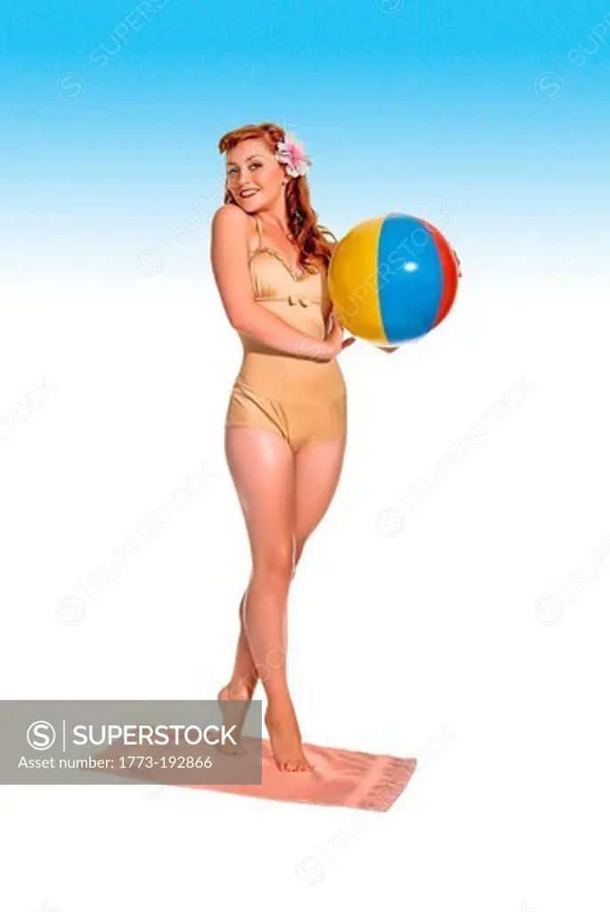 Retro-styled young woman in swimming costume with beach ball