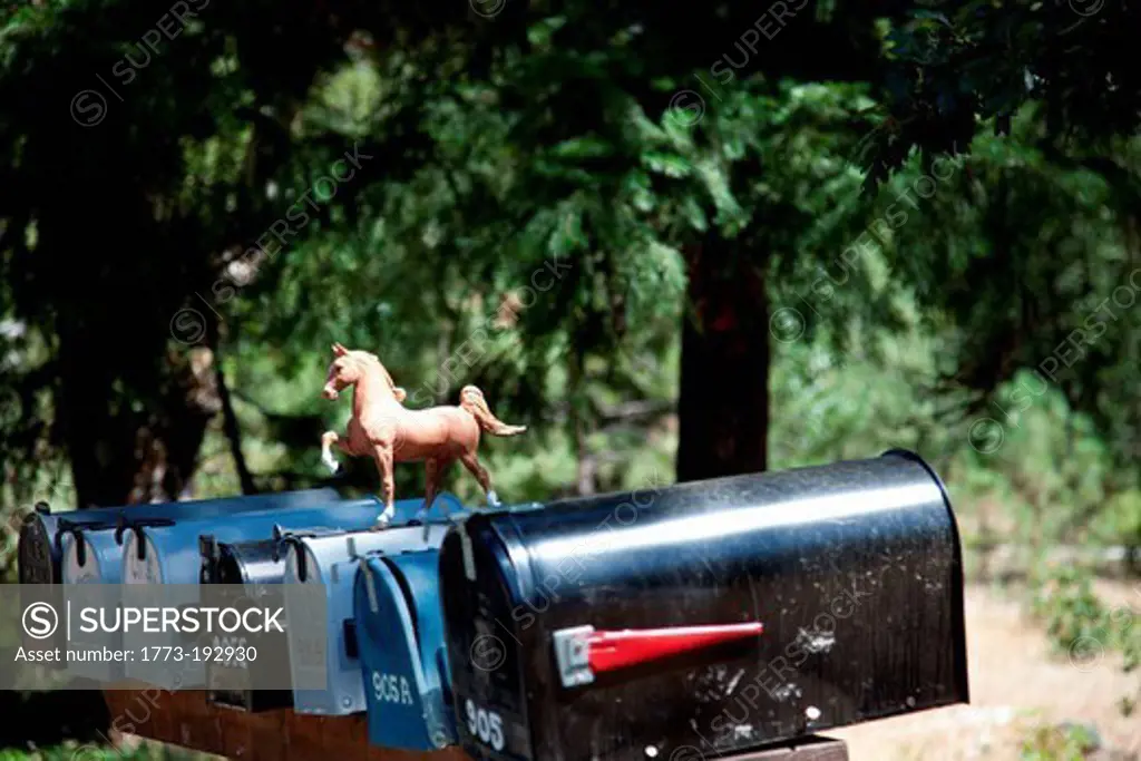 Rural mailboxes with plastic horse figurine
