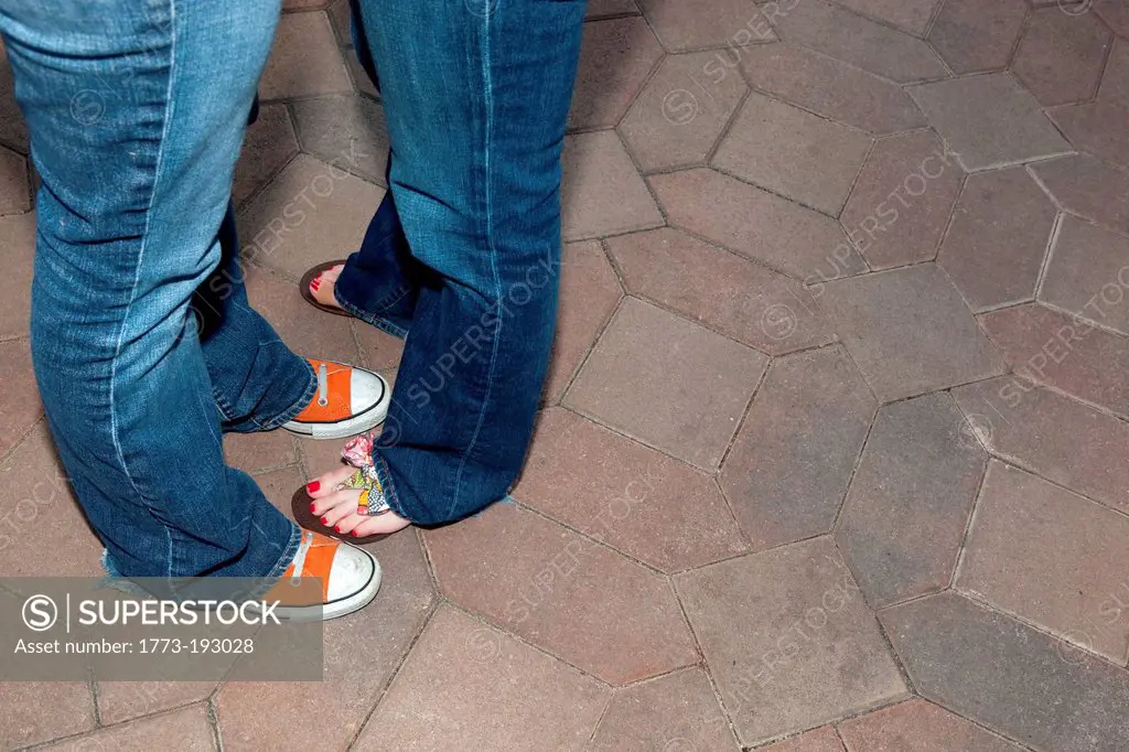 Young lesbian couple embracing, low angle view