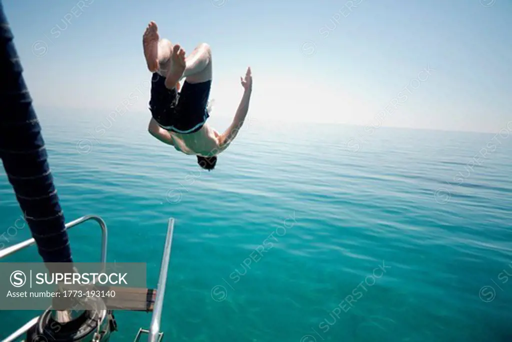 Man jumping head first into the sea