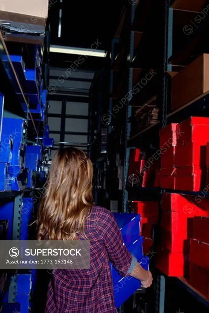 Teenage girl working in stock room