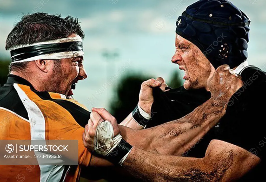 Rugby players grappling with each other