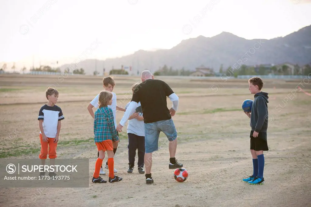 Soccer coach mentoring boys