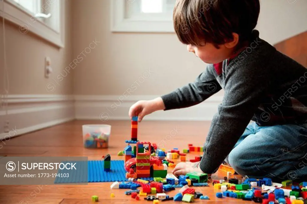Boy playing with plastic blocks