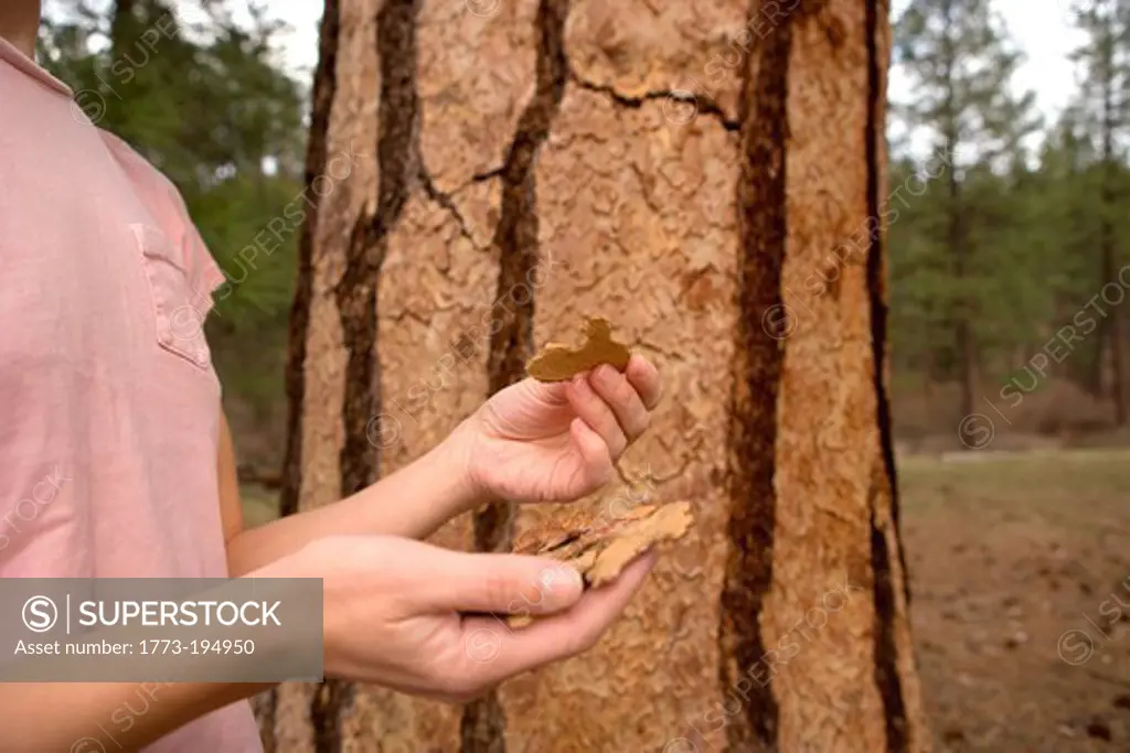 Woman holding tree bark