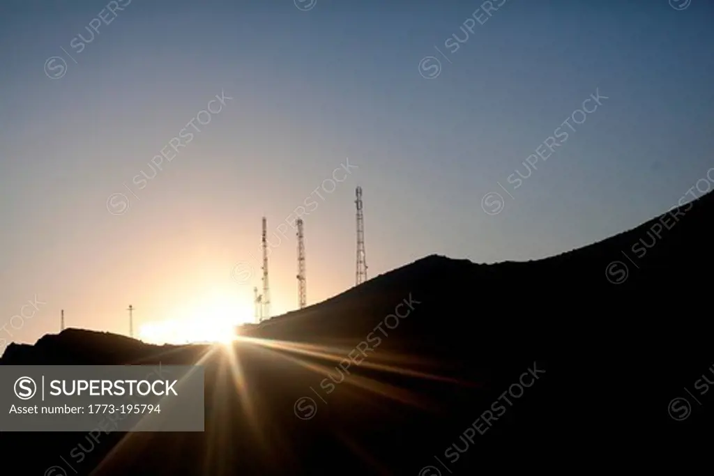 Mountains and communication towers in sunlight