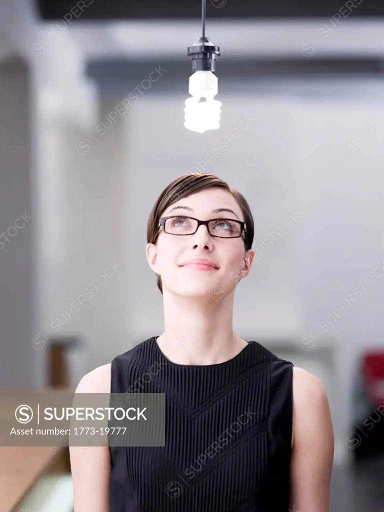 Woman looking at a light bulb