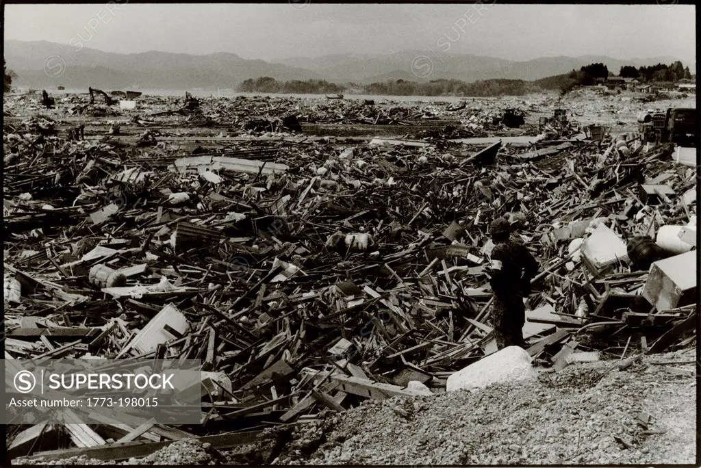 Rikuzentakata, Japan- 20th March 2011: Soldier amongst debris in aftermath of the 2011 Tohoku Earthquake and Tsunami