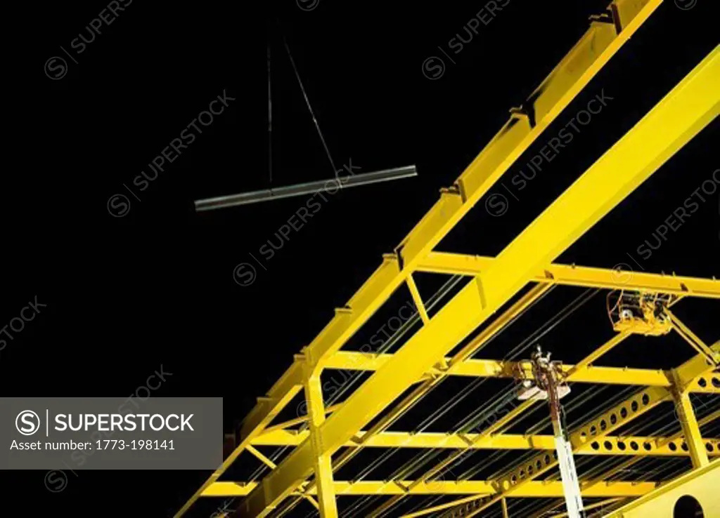 Yellow steel girder framework on construction site
