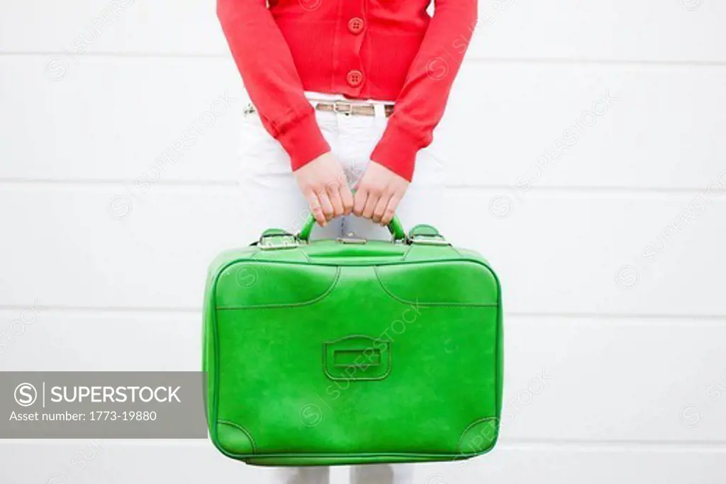 Girl holding suitcase