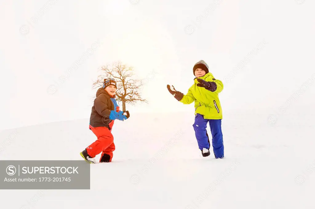 Two boys playing in snow