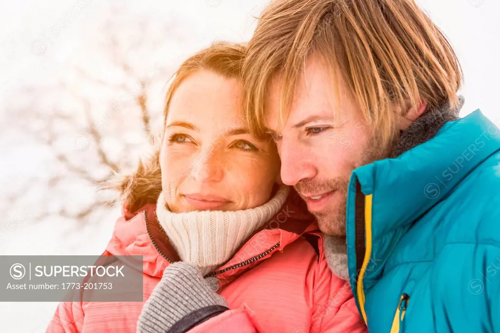 Portrait of couple wearing winter coats, close up