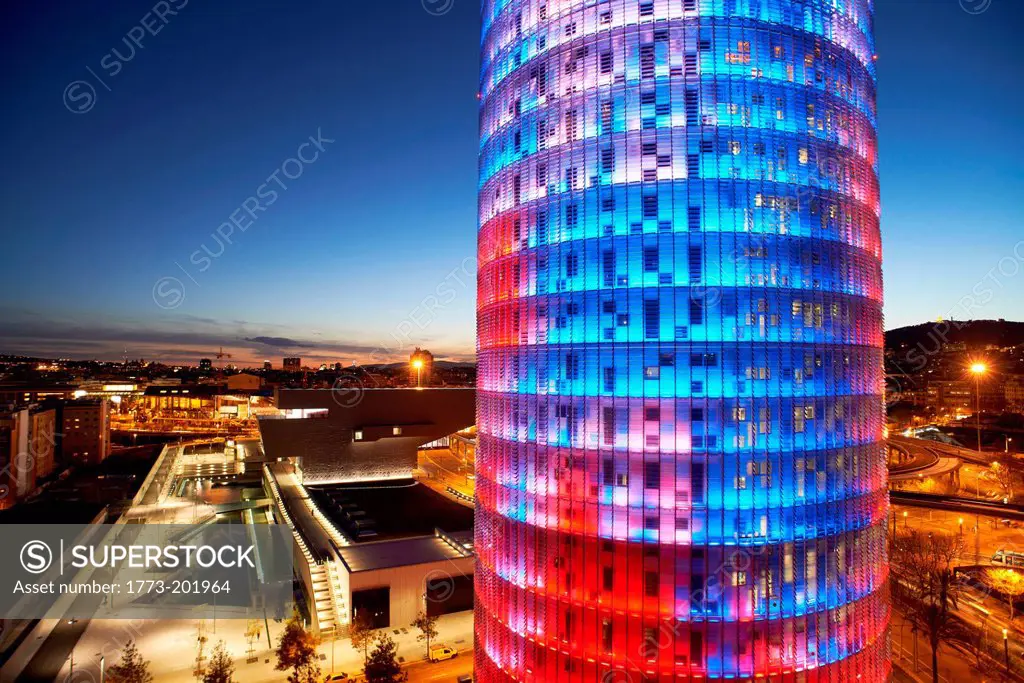 Torre Agbar skyscraper illuminated blue and red, Barcelona, Spain