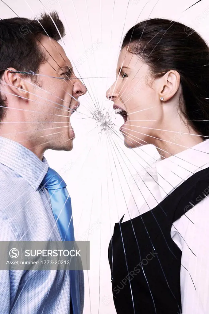 Young man and woman behind cracked glass shouting at each other